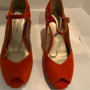 Orange suede wedge shoes.